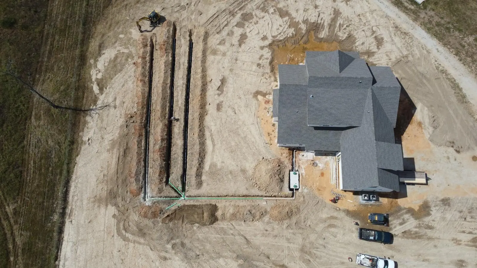 Aerial view of a septic lateral field beside a new house